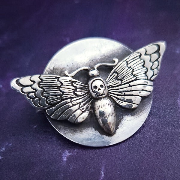 The KYRO INTERCHANGEABLE MEDALLIONS are created to wear on the KYRO COLLARS and can be effortlessly changed. In a heartbeat, you can transform a collar from gothic to girly, uptown to downtown, or casual to dramatic. This one is sterling DEATH'S HEAD MOTH by My Secret Heart Studios.