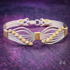 Artisan wire wrapped bracelet is created with precious metals. Hand sculpted into soft wings and embellished with strategically placed beads to form a fluttering butterfly. By My Secret Heart Studios