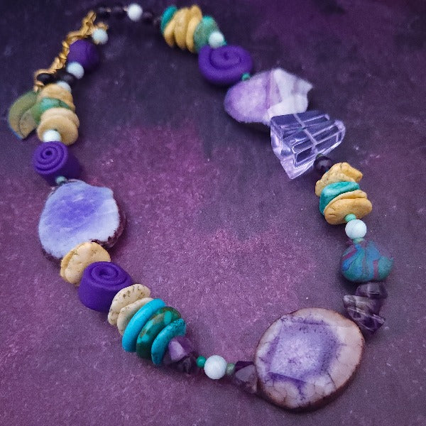 Empower yourself and feel beautiful with our bold Lavi Gemstone Collar. The large, eye-catching slices of Amethyst Sliced Agate will surely turn heads your way. A locking submissive collar that is completely unexpected!