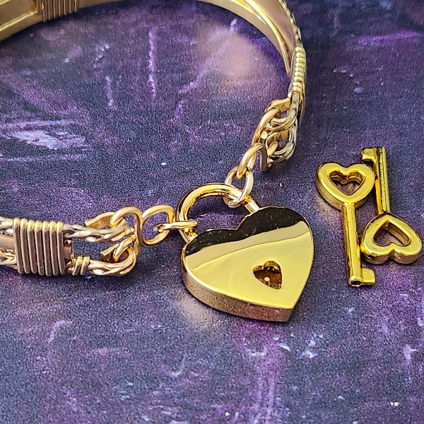 Bold, original and dramatic, this locking submissive bracelet is from our Limited Edition BABYLON COLLECTION.  My Secret Heart StudiosBold, dramatic and luxurious, these bracelets are from our BABYLON Collection. Babylonian jewelry was not only a way to add style but also represented wealth, status, and spiritual reverence. An exquisite craft, attention to detail, and artistic prowess left a permanent impression in the world of ancient jewelry.