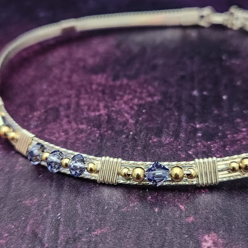 Make an unforgettable statement with our one-of-a-kind gemstone Babei collar! Crafted with sterling silver and beautiful Tanzanite gemstone crystal beads, this stunning necklace will instantly add a sophisticated yet daring touch to any look. Dare to be different and be noticed!
