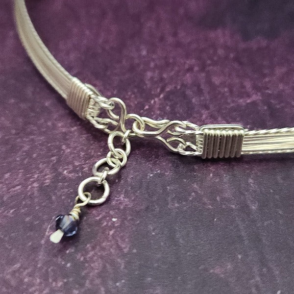 Make an unforgettable statement with our one-of-a-kind gemstone Babei collar! Crafted with sterling silver and beautiful Tanzanite gemstone crystal beads, this stunning necklace will instantly add a sophisticated yet daring touch to any look. Dare to be different and be noticed! By My Secret Heart Studios