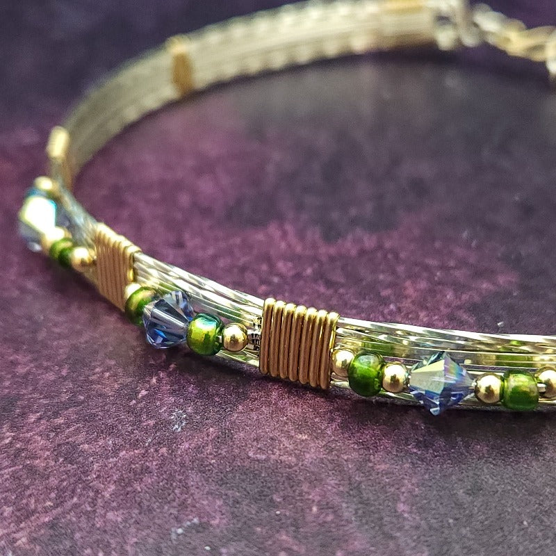 Make an unforgettable statement with our one-of-a-kind gemstone Babei collar! Crafted with sterling silver and beautiful Tanzanite gemstone crystal beads, this stunning necklace will instantly add a sophisticated yet daring touch to any look. Dare to be different and be noticed!
