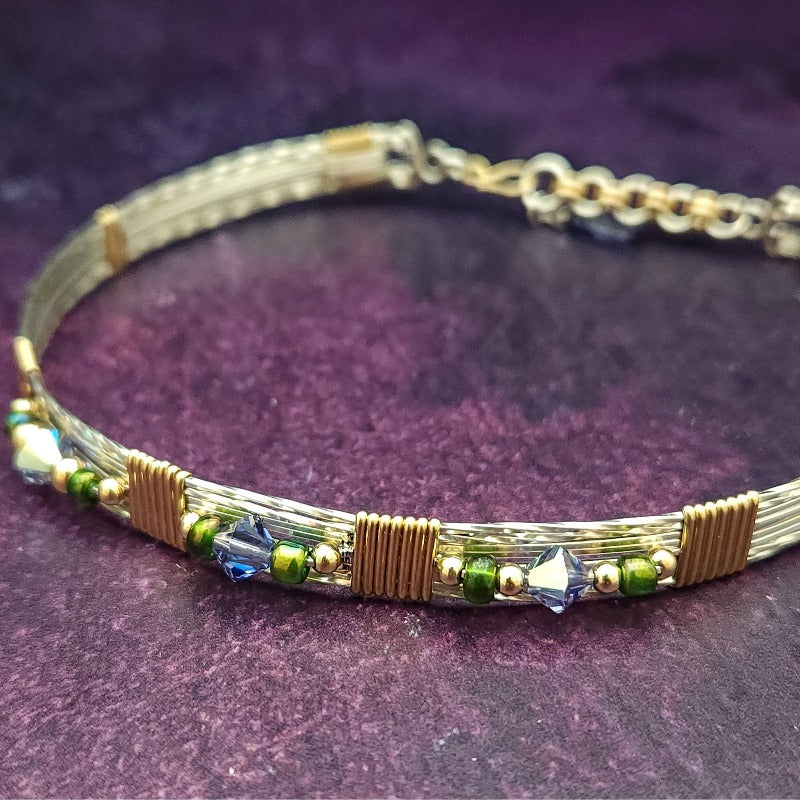 Make an unforgettable statement with our one-of-a-kind gemstone Babei collar! Crafted with sterling silver and beautiful Tanzanite gemstone crystal beads, this stunning necklace will instantly add a sophisticated yet daring touch to any look. Dare to be different and be noticed!