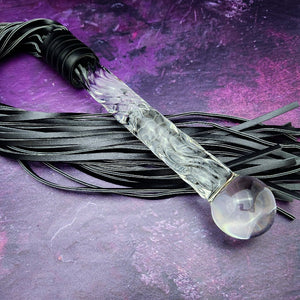 Experience the perfect balance of pleasure and pain with this BDSM Flogger in Black Leather and Glass! Stylish, luxurious, and crafted with great care, it's the classic impact toy of your kinky dreams. Personalize to your heart's content - heat it up or hit it hard - and explore a range of sensations with S&M play! Can be Monogrammed / Engraved. By My Secret Heart Studios