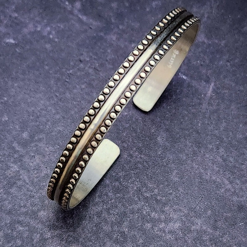 A classic cuff reminiscent of Ancient Rome and it's soldiers. Sterling silver with button studded edges. By My Secret Heart Studios