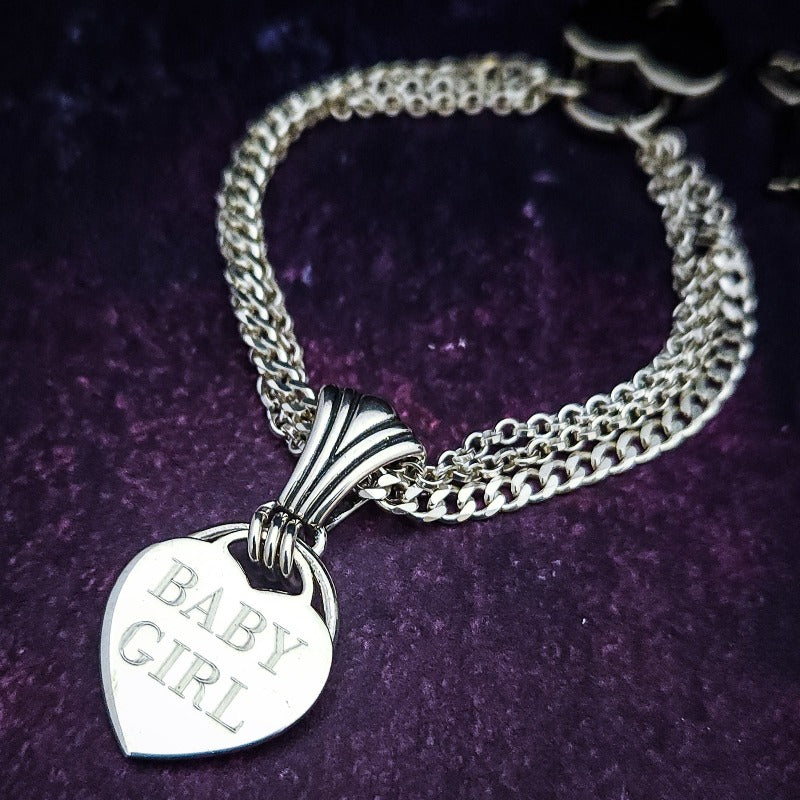 A Baby Girl is a rare and beautiful girl. Proclaim her status and Your Ownership with this sexy bracelet to celebrate submission. HIDDEN O RING can accommodate a leash or a connection point. The SLIDE can be worn on chain or thin collars, as well as worn on a chain as a pendant. Wear it locked with the small heart lock