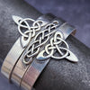 This traditional classic CELTIC DANCE cuff, adorned with a sterling Triquetra Knot, pays homage to the spirited nights of Celtic music and dancing. Its robust design ensures a lifetime of use, while the polished sterling silver offers a lustrous shine that never fades. This timeless piece of Celtic jewelry is sure to be a conversation starter.