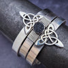 This traditional classic CELTIC DANCE cuff, adorned with a sterling Triquetra Knot, pays homage to the spirited nights of Celtic music and dancing. Its robust design ensures a lifetime of use, while the polished sterling silver offers a lustrous shine that never fades. This timeless piece of Celtic jewelry is sure to be a conversation starter.