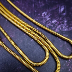Luxurious BDSM leash for that special time or event. The Golden Snakeskin Leather is accented gold wire wraps and features an earthy toned natural Pyrite gemstone. Riveted for strength. The 35 inch golden brass snake chain is slinky with a sensual feel.  A swivel trigger clip moves with you both for great mobility. This is uber-sexy! My Secret Heart Studios