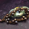 Make a bold statement with MARNIA, the one-of-a-kind necklace featuring titanium druzy, freshwater pearls, and a handcrafted bronze medallion ammonite. Turn heads with the vibrant colors and asymmetrical design, guaranteed to make you look and feel unforgettable!