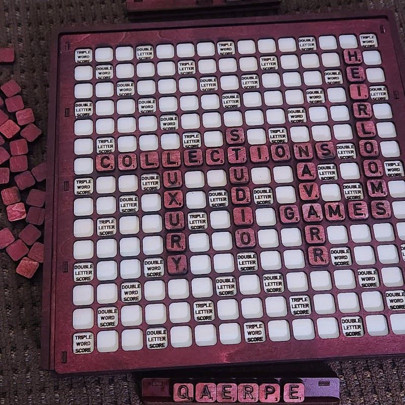 A vintage-style Scrabble board game set with a dark reddish-brown wooden grid, white square tiles, and pinkish-red letter tiles. The board is filled with words, and several loose red tiles are visible on the left side.