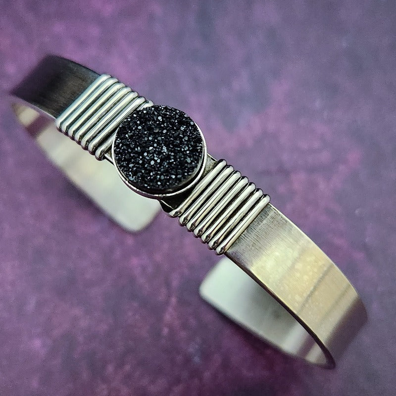 The substantial weight of The Simplicity sterling cuff lends this a sense of gravitas, while a powerful black druzy is embraced by sterling silver wraps. The simplistic design makes it a perfect companion for almost any other jewelry in your collection.  Goes beautifully with our Celtic Inspired Cuffs. By My Secret Heart Studios