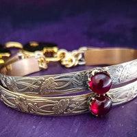 Show your ownership or submission with style and grace. Our best selling ‘SOFT and SWEET’ Locking BDSM submissive handcuff bracelets are now available in anklets sizes as well. These artisan handcuffs / ankle restraints are hand crafted in a pretty feminine floral pattern of 14kGold-Fille and natural Garnet. The epitome of feminine grace. 
