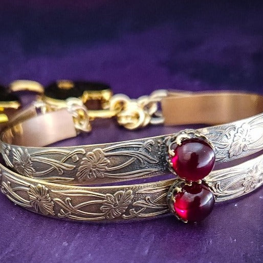 Show your ownership or submission with style and grace. Our best selling ‘SOFT and SWEET’ Locking BDSM submissive handcuff bracelets are now available in anklets sizes as well. These artisan handcuffs / ankle restraints are hand crafted in a pretty feminine floral pattern of 14kGold-Fille and natural Garnet. The epitome of feminine grace. 