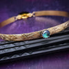 Our Soft and Sweet submissive collar is the epitome of feminine grace. Handcrafted with loving care, this artisan-made 14k gold filled submissive collar radiates femininity with its floral sterling silver pattern and a hand-set 8mm Azotic Galazio Blue Topaz. Beautifully feminine and romantic.