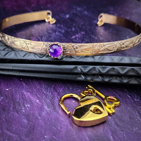 Our Soft and Sweet submissive collar is the epitome of feminine grace. Handcrafted with loving care, this artisan-made 14k gold filled submissive collar radiates femininity with its floral sterling silver pattern and a hand-set 8mm Amethyst. Beautifully feminine and romantic.