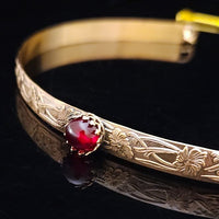 Our NEW GOLD & GARNET Soft and Sweet submissive collar and cuffs are the epitome of feminine grace. Handcrafted with loving care, these artisan-made 14k gold filled submissive collars and cuffs radiate femininity with a floral pattern and a hand-set 8mm Natural Amethyst. Beautifully feminine and romantic.