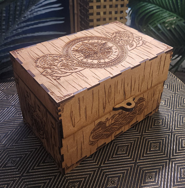 Celtic Dragon Stash Box, Oak, on a table with geometric textures