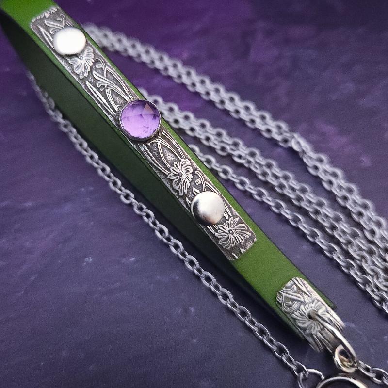 Never settle for ordinary when you can have extraordinary! Our submissive pet leash is handcrafted and One Of A Kind. Bright and clear Peridot green leather is accented with a plaque of our beloved Soft and Sweet pattern in sterling, and boast a rose cut amethyst cabochon for some glitz and glamour.