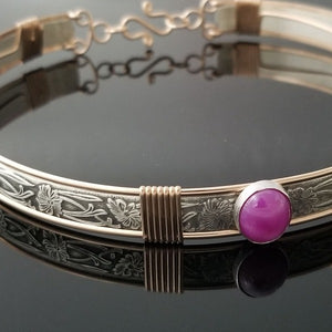 THIS LIMITED EDITION SUBMISSIVE COLLAR is part of our SOFT and SWEET Collection and is created in sterling silver and accented with Rose Gold Filled wire accents. The luxurious 12mm x 10mm Star Ruby Cabochon is hand set in a sterling silver bezel. What a luxurious way to show you Ownership / submission. 
