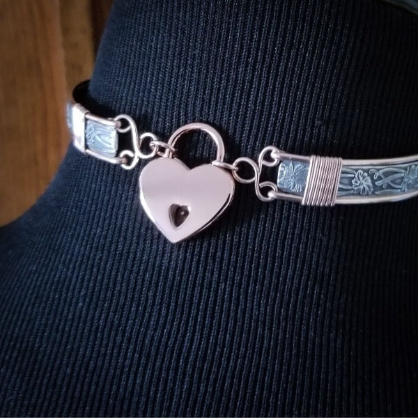 THIS LIMITED EDITION SUBMISSIVE COLLAR is part of our SOFT and SWEET Collection and is created in sterling silver and accented with Rose Gold Filled wire accents. The luxurious 12mm x 10mm Star Ruby Cabochon is hand set in a sterling silver bezel. What a luxurious way to show you Ownership / submission. 