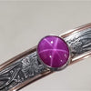 THIS LIMITED EDITION SUBMISSIVE COLLAR is part of our SOFT and SWEET Collection and is created in sterling silver and accented with Rose Gold Filled wire accents. The luxurious 12mm x 10mm Star Ruby Cabochon is hand set in a sterling silver bezel. What a luxurious way to show you Ownership / submission. 