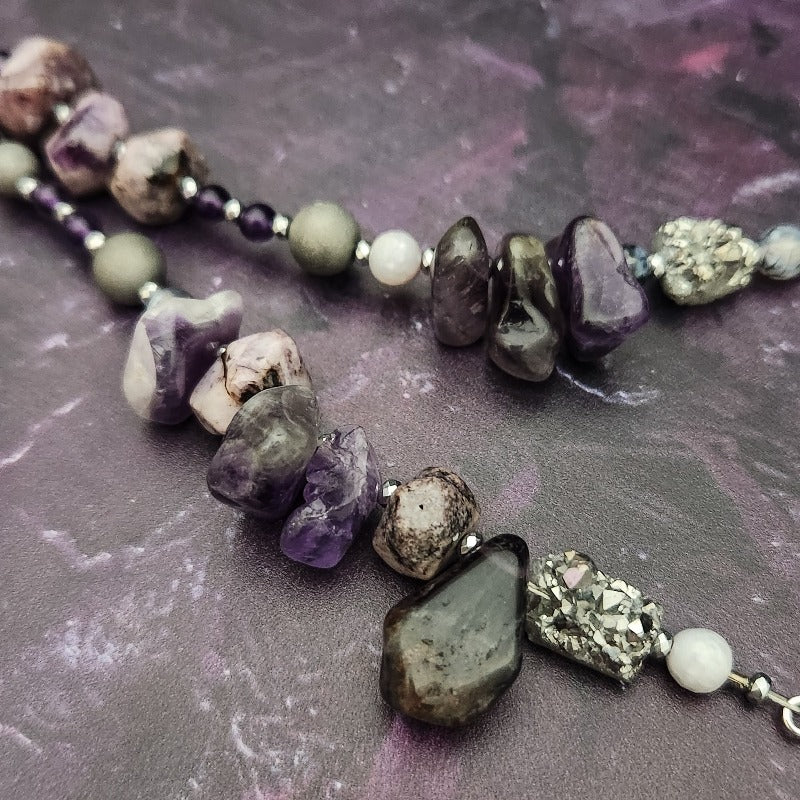 Wear the Velavee Angel Necklace and radiate your inner goddess! Crafted from sterling silver and the rare gemstone Charoite, this one-of-a-kind necklace is adorned with angel wing and a inverted fan shaped medallion, creating a beautiful and unique statement. 