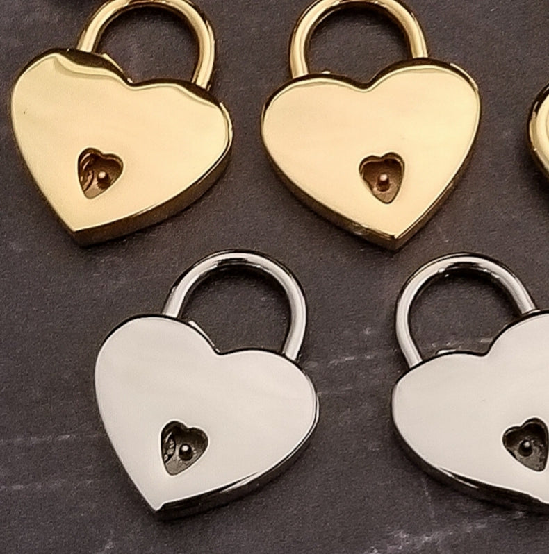 Four MY SECRET HEART STUDIOS heart shaped padlocks in gold, silver and copper.