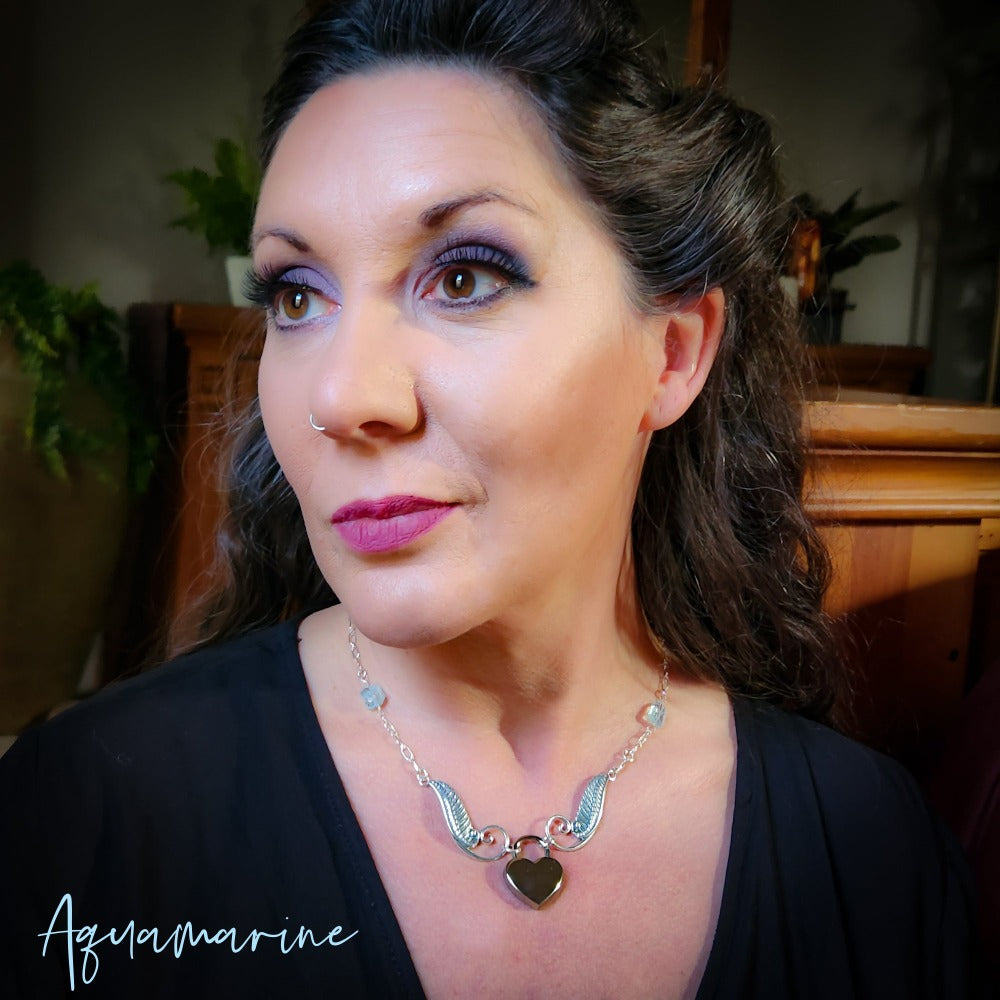 This ONE OF A KIND locking submissive ANGEL WING GEMSTON E COLLAR pays homage to your BDSM D/s lifestyle with beauty and grace. Locks in front.  GEMSTONES: Faceted  Amethyst Nuggets, Cushion Cut Labradorite , Faceted Tanzanite Rondels & Faceted Grey Moonstone