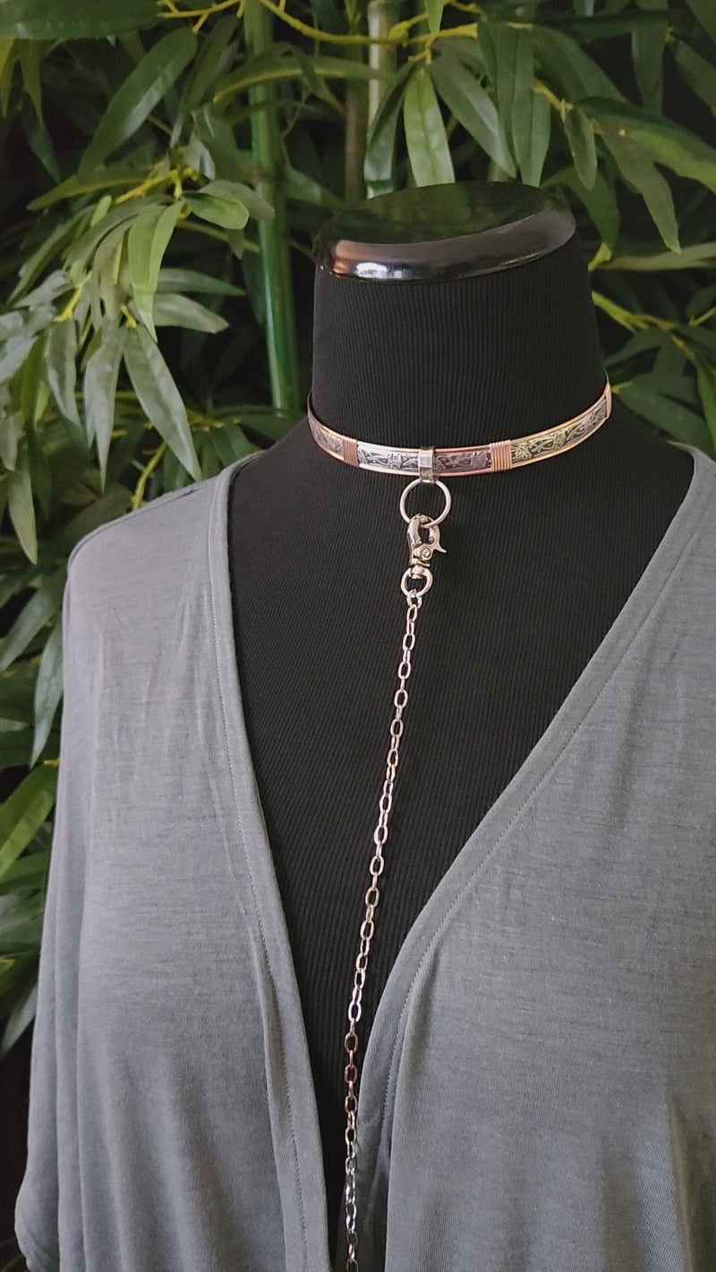 Simplicity. A sleek and simple chain collar of Stainless Steel gets it done. The handle is 10 inches of chain, so both small and large hands should fit easily. The 36 inch chain ends with a silver tone swivel trigger clip. Features a handcrafted sterling O Ring with a bail opening large enough to fit most all of our collars.