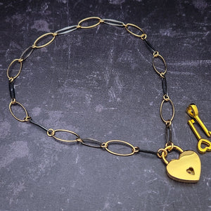  Opulent is sure to make a striking statement day or night. The chain is easily transformed into stylish handcuff or ankle restraint, a chic locking collar, or a decorative necklace for Dominants. Connect it to the back of a collar for a sexy look, and give a tug on the chain for an extra choking sensation. Handcrafted in blackened sterling and gold links, Opulent is beautifully dramatic and luxurious, 