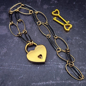  Opulent is sure to make a striking statement day or night. The chain is easily transformed into stylish handcuff or ankle restraint, a chic locking collar, or a decorative necklace for Dominants. Connect it to the back of a collar for a sexy look, and give a tug on the chain for an extra choking sensation. Handcrafted in blackened sterling and gold links, Opulent is beautifully dramatic and luxurious.