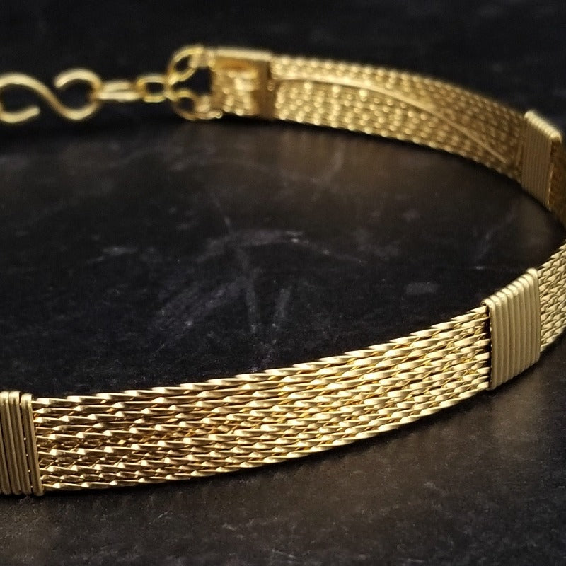 Showcase your power and taste with ASHANTI Slim Collar. This handcrafted collar is artfully crafted with twisted 14K gold filled wire and elevated with gold wraps. A touch of chain in the back ensures a snug fit, so you can move with ease. Wear ASHANTI TWISTED alone or layer it with other chains and pendants--it's the perfect foundation for building endless elegant looks! Plus, the locking collar takes your look up a notch. 