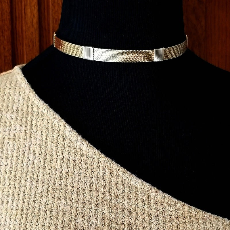 Showcase your power and taste with ASHANTI Slim Collar. This handcrafted collar is artfully crafted with twisted 14K gold filled wire and elevated with gold wraps. A touch of chain in the back ensures a snug fit, so you can move with ease. Wear ASHANTI TWISTED alone or layer it with other chains and pendants--it's the perfect foundation for building endless elegant looks! Plus, the locking collar takes your look up a notch. 