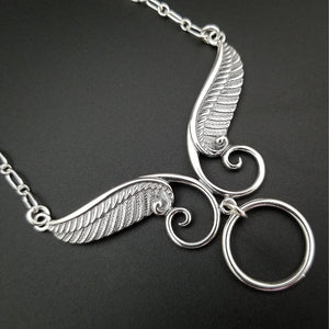 An locking, soft collar for your angel. This angel wing collar pays homage to your BDSM D/s lifestyle and has an O ring attached. Can be worn locked, or with a traditional clasp for discretion. Created with sterling silver chain, suitable for everyone, everyday. Do you think anyone will know what the classic 'Story of O' ring is for??