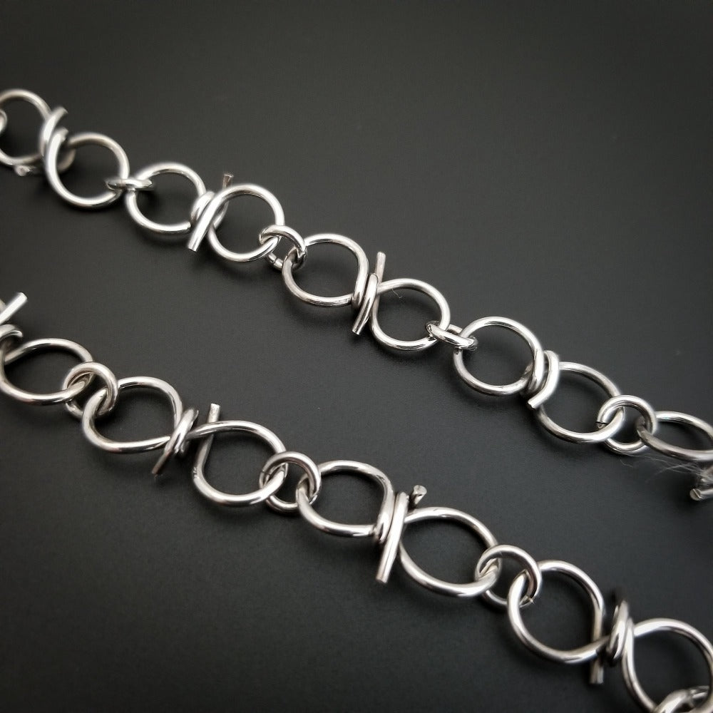 Our version of a Barbed Wire Collar, this beast is from our Brambles Collection, inspired by barbs, thorns and prickly things. This BDSM LOCKING SUBMISSIVE COLLAR is thick, hefty and truly badass. I create the barbs with comfort in mind, they're smooth and aren't long enough to do real damage, but still just a touch dangerous ;D