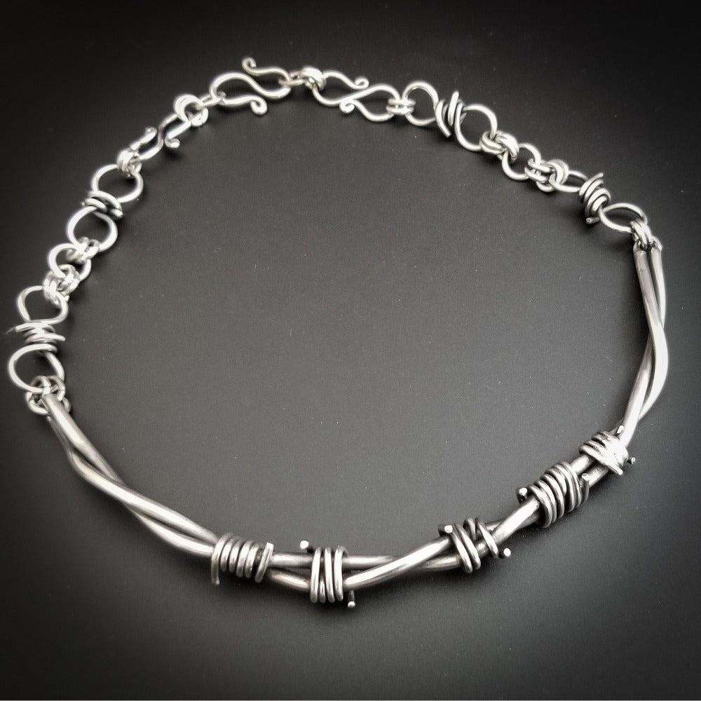 Our version of the a Barbed Wire Collar, this beast is from our Brambles Collection, inspired by barbs, thorns and prickly things. This BDSM themes LOCKING SUBMISSIVE COLLAR is thick, hefty and truly badass. I create the barbs with comfort in mind, making sure they're smooth and aren't long enough to do real damage, but still just a touch dangerous ;D