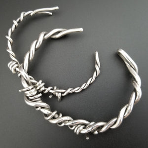 Our version of the a Barbed Wire Cuff, this beast is from our Brambles Collection, inspired by barbs, thorns and prickly things. This cuff is thick, hefty and badass. I create the barbs with comfort in mind, making sure they're smooth and aren't long enough to do real damage, but still just a touch dangerous ;D