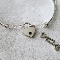 Our most delicate and feminine submissive locking collar. A simply sweet floral and vine pattern of sterling silver and wire wrapped with precious metal accents. BDSM? No one will know. Totally discreet.