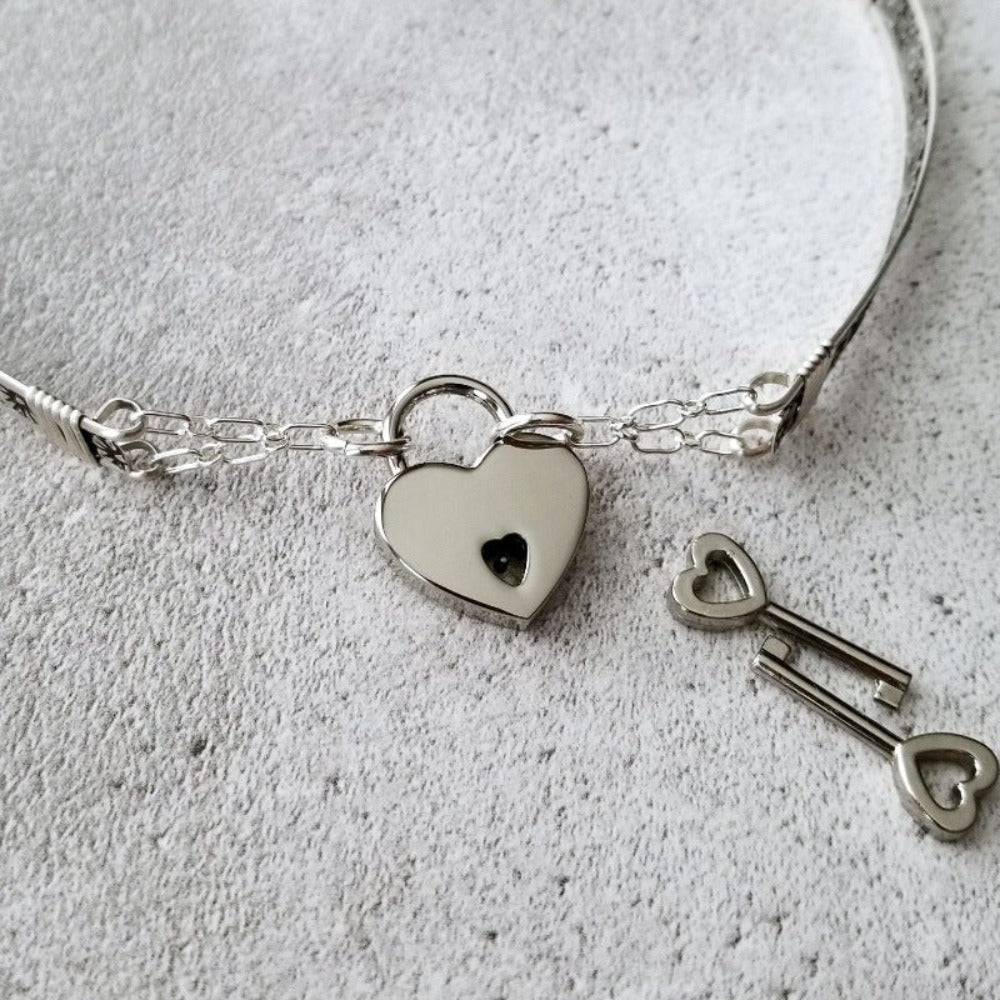 Our most delicate and feminine submissive locking collar. A simply sweet floral and vine pattern of sterling silver and wire wrapped with precious metal accents. BDSM? No one will know. Totally discreet.