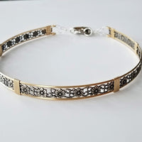 Our most delicate and feminine submissive locking collar. A simply sweet floral and vine pattern of sterling silver and wire wrapped with precious metal accents. BDSM? No one will know. Totally discreet.