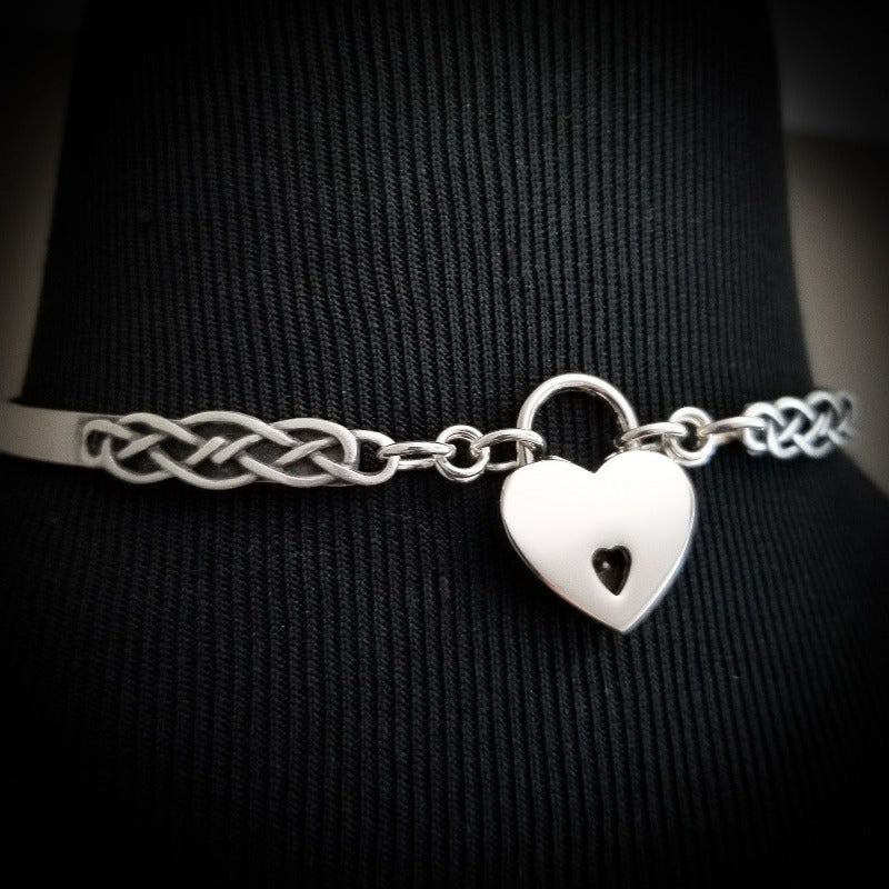  A Celtic inspired locking submissive collar that's sleek and clean in the front, and embellished with Celtic knots in the back. Or... reverse it and wear the decorative design in the front with the lock, for a bold statement of Ownership. Since it's unadorned in the front, you can easily change the look with collar enhancers / slides.