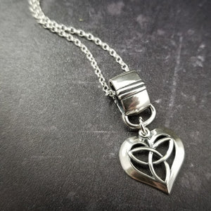 Symbolizing eternity love, this Celtic Heart is a sweet reminder of your love. Features a sterling silver chain, but can be worn on most of our BDSM locking submissive collars. Sterling silver.