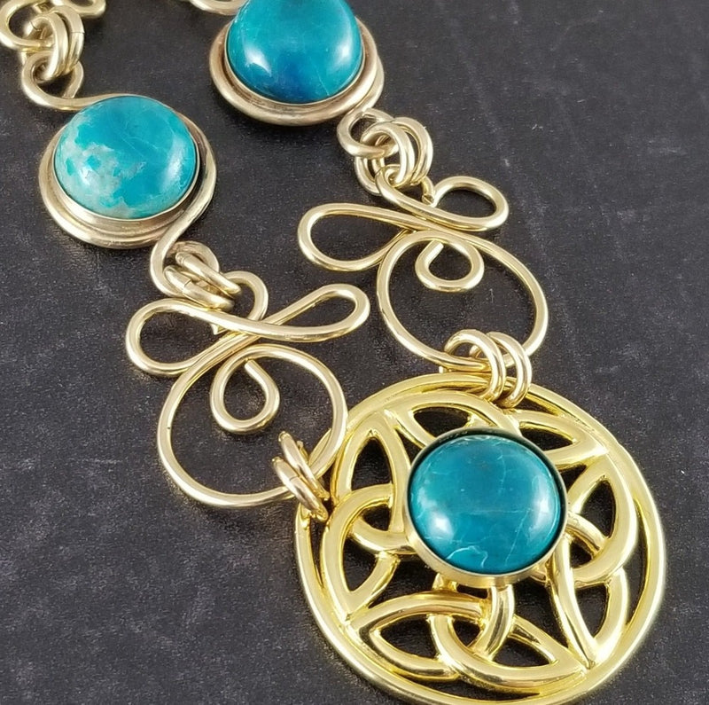THE CELTIC PRIESTESS COLLAR features chain links inspired by Celtic knots, all created entirely by hand using only a few hand tools. The links are then tumbled with steel shot, creating strength and durability, as well as a silky smoothness.