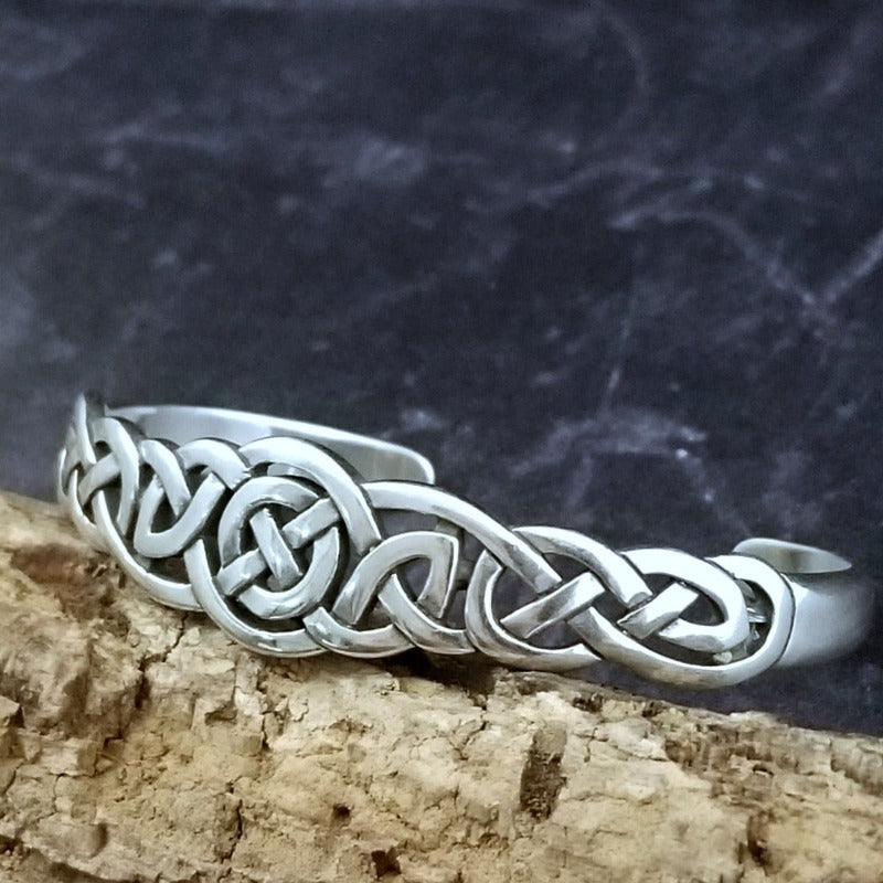 An intricate openwork Celtic weave design in all sterling silver cuff. Wear alone, or stack with some simpler designs for an bold look.