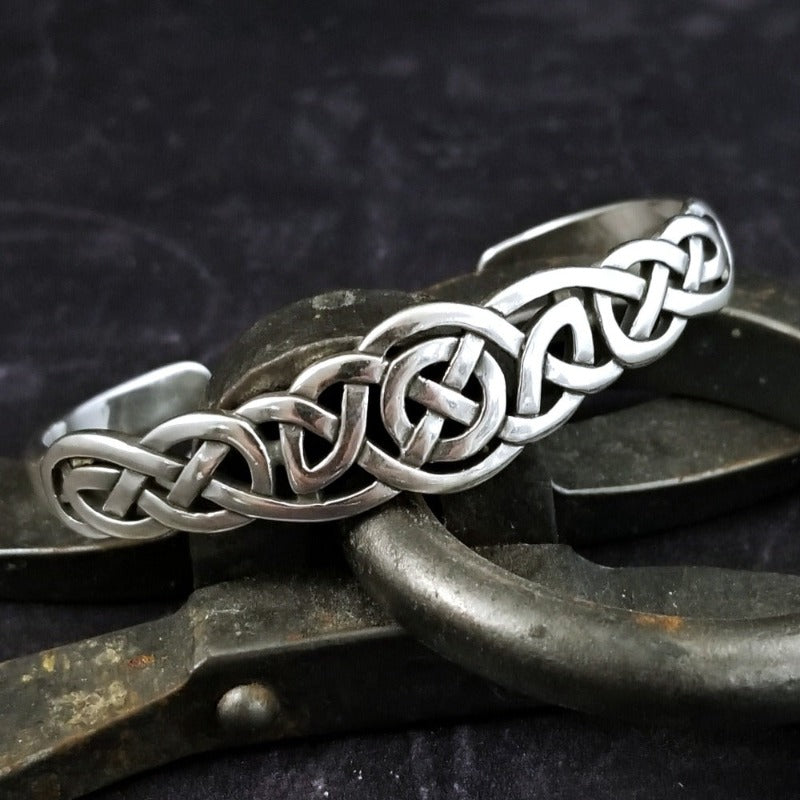 An intricate openwork Celtic weave design in all sterling silver cuff. Wear alone, or stack with some simpler designs for an bold look.