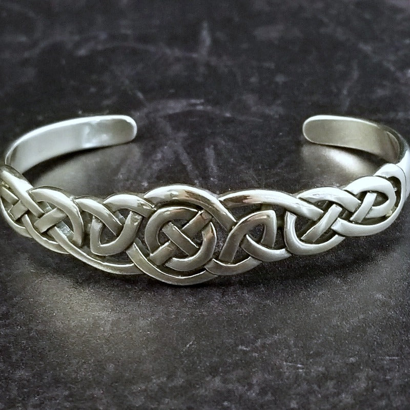 An intricate openwork Celtic weave design in all sterling silver cuff. Wear alone, or stack with some simpler designs for an bold look.