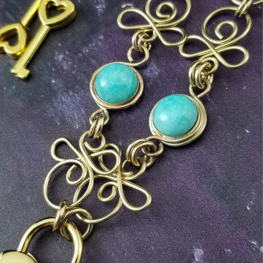 Made a bold statement of your Dominant / submissive lifestyle. The CELTIC PRIESTESS locking submissive collar features chain links inspired by Celtic knots, all created entirely by hand. Embellished with 2 natural amazonite cabochons of your choice. My Secret Heart Studios 001