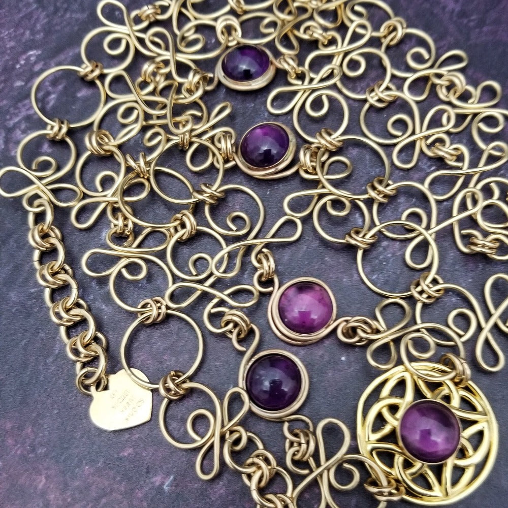 THE CELTIC PRIESTESS LOCKING BELT features chain links inspired by Celtic knots, all created entirely by hand using only a few hand tools. The links are then tumbled with steel shot, creating strength and durability, as well as a silky smoothness. Amethyst and Gold Filled. By My Secret Heart Studios